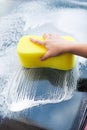 Hand Washing Windscreen With Yellow Sponge