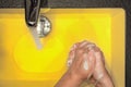 Hand washing in yellow Royalty Free Stock Photo