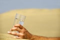Hand and water in desert Royalty Free Stock Photo