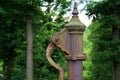 Hand water pump. Old Manual pump well in park. Photo of old style well object. Old Antique metal mechanism Royalty Free Stock Photo