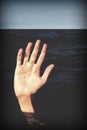 Hand on the sea of a person who is drowning and seeks help