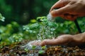 Hand waters tiny plant with hose sending it airborne, water conservation image