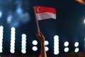 Hand waving singapore flag during Singapore`s 54th national day parade on 9th august 2019