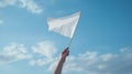 hand waving white flag against blue sky