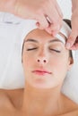 Hand waxing beautiful woman's eyebrow Royalty Free Stock Photo