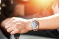 Hand wear a watch and drive a car