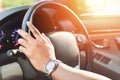 Hand wear a watch and drive a car