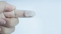 A hand wearing baby tooth brush or infant tooth brush, helping the first teeth clean isolated on white some negative space Royalty Free Stock Photo