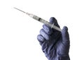 A hand wearing a blue glove holding a syringe isolated on a white background Royalty Free Stock Photo