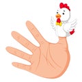 Hand wearing a rooster finger puppet on thumb