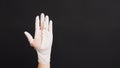 Hand Wearing torn latex glove or torn rubber gloves on black background Royalty Free Stock Photo