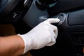 Hand wearing white gloves and pushing button start/stop car engine Royalty Free Stock Photo