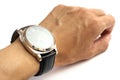 A hand wearing a wristwatch for men with large face and black leather straps Royalty Free Stock Photo