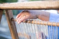 The hand of a weaver using a loom in Lunigiana