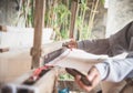 The hand of a weaver is woven with a hand-woven machine