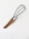 hand whisk for kitchen with wooden handle on white background