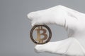 Hand in White Glove holds Golden Bitcoin Crypto Currency Royalty Free Stock Photo