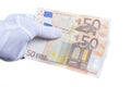 A hand with a white glove placed holds a hundred euros Royalty Free Stock Photo