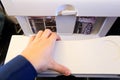 Hand on white passenger airplane table