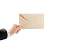 The hand in white shirt and black jacket holding the envelope. Close up. Isolated on white background Royalty Free Stock Photo