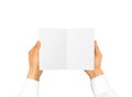 Hand in white shirt sleeve holding blank booklet card in the han Royalty Free Stock Photo