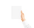 Hand in white shirt sleeve holding closed blank book. Royalty Free Stock Photo