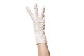 Hand in a white sterile medical glove shows gesture three fingers. Royalty Free Stock Photo