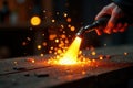 A hand wielding a torch ignites a fiery spectacle, sparks illuminating a rustic wooden surface. Generative AI Royalty Free Stock Photo
