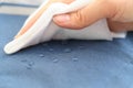 hand wipes drops of water from a cloth. Water drops on waterproof textile material. short depth of field. Waterproof Royalty Free Stock Photo