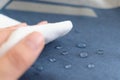hand wipes drops of water from a cloth. Water drops on waterproof textile material. short depth of field. Waterproof Royalty Free Stock Photo