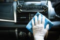 The hand wipes the interior of the car with a rag. Car disinfecting service