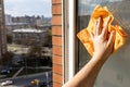 hand wipes open street window at home with rag