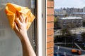 hand wipes open window with rag in city house