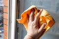 hand wipes window glass in high-rise city house Royalty Free Stock Photo