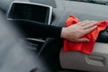 Hand wiping car interior with rug. Disinfection and cleaning concept. Killing coronavirus on touching surface of auto. Console car