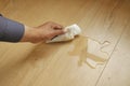 hand wiping spilled tea with paper napkin on floor , Royalty Free Stock Photo