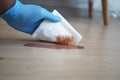 hand wiping spilled tea with paper napkin on floor , Royalty Free Stock Photo