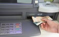 withdrawing euro banknotes in automatic teller machine in Europe