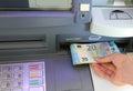hand while withdrawing money European banknotes from an ATM cash Royalty Free Stock Photo