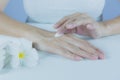 Hand of woman apply lotion on skin of back hand Royalty Free Stock Photo
