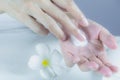 Hand of woman apply lotion on skin of hand Royalty Free Stock Photo