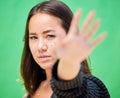 Hand of woman blur, portrait of stop sign gesture or young asian girl warning dont on green screen background. Female