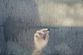Hand of woman in the car window with rain drop. Loneliness and depression concept. Royalty Free Stock Photo