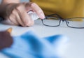 Hand woman cleaning her glasses,Clean lenses of eyeglasses