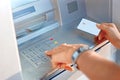 Hand of a woman with a credit card, using an ATM. Woman using an ATM machine with her credit card. Royalty Free Stock Photo