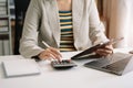 Hand woman doing finances and calculate on desk about cost at home office Royalty Free Stock Photo