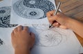 Hand of woman drawing yin yang for anti stress coloring book