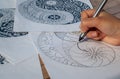 Hand of woman drawing yin yang for anti stress coloring book