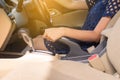 Hand woman driver pulling the hand a parking brake inside car Royalty Free Stock Photo