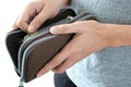 Hand of woman grab a coin gold from he wallet brown to be used in the shopping..Money and spending ideas Royalty Free Stock Photo